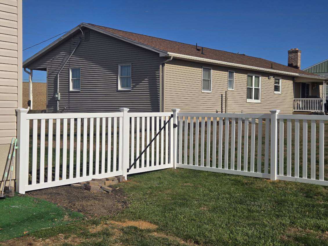 new white vinyl fence in front of house