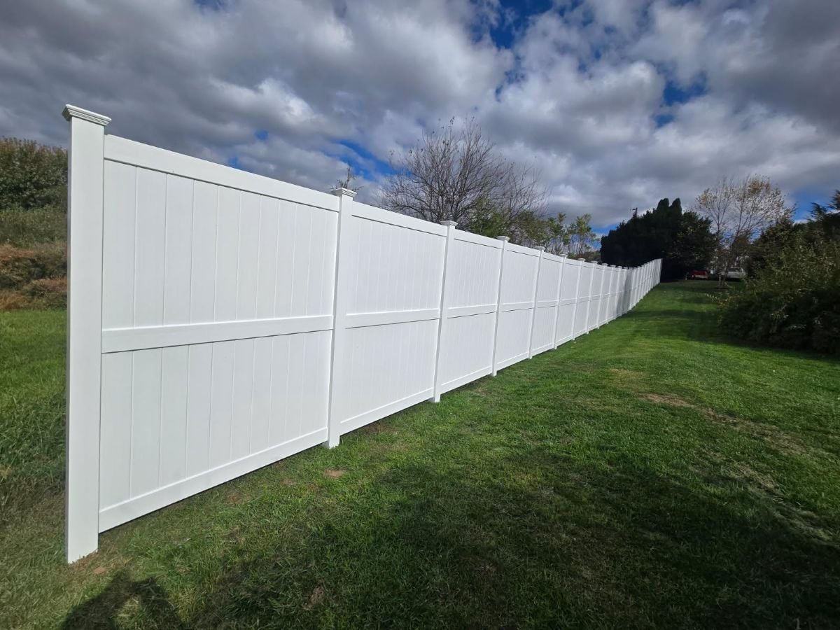 white vinyl fence against blue sky