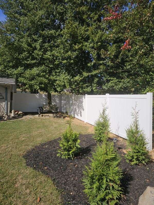 white vinyl fence in a yard